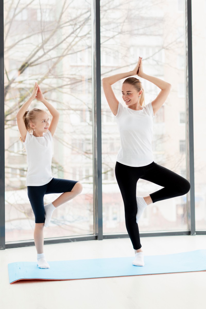 yoga pose with mother smiley daughter home 1